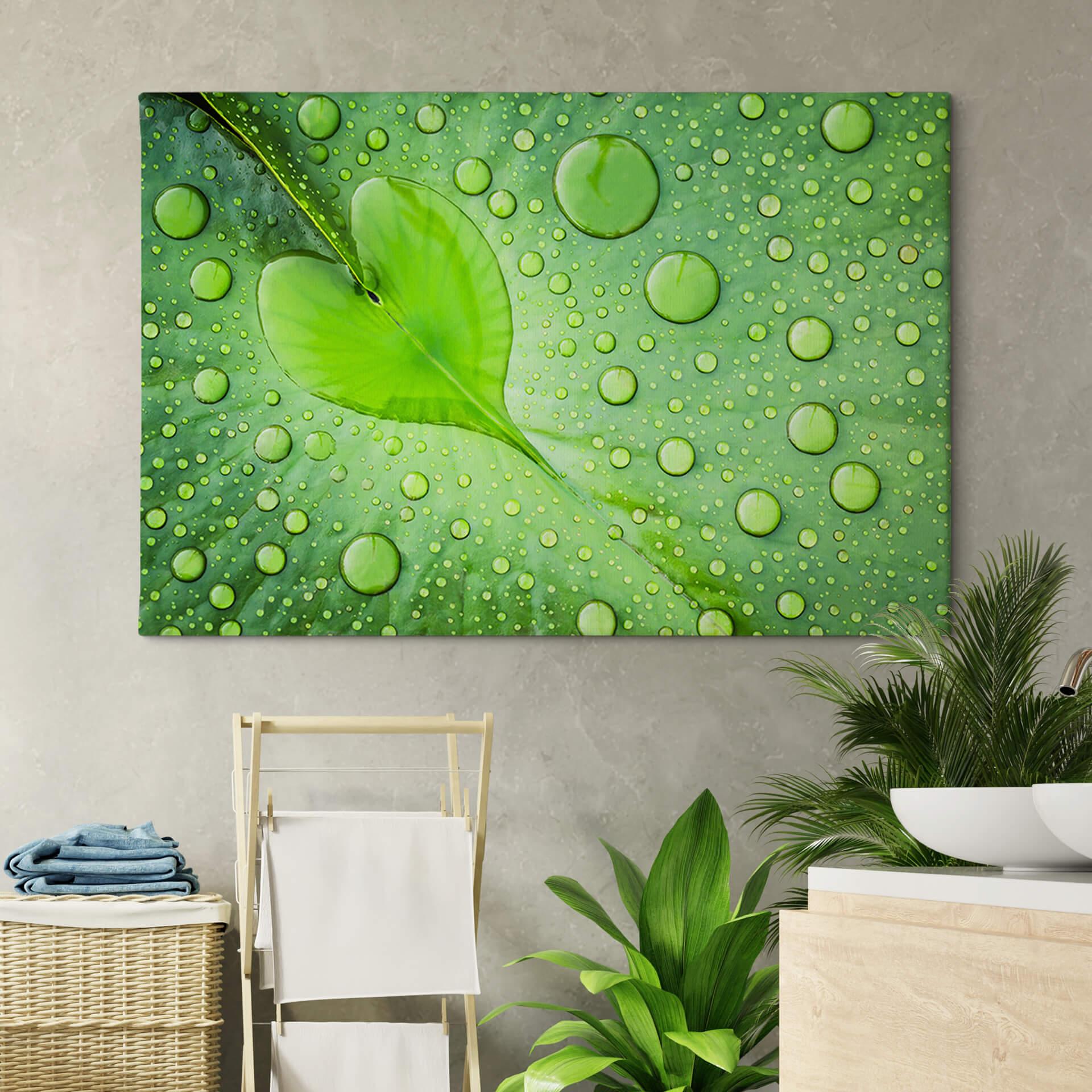 Foto en lienzo - Corazón de gotas de agua sobre una hoja verde