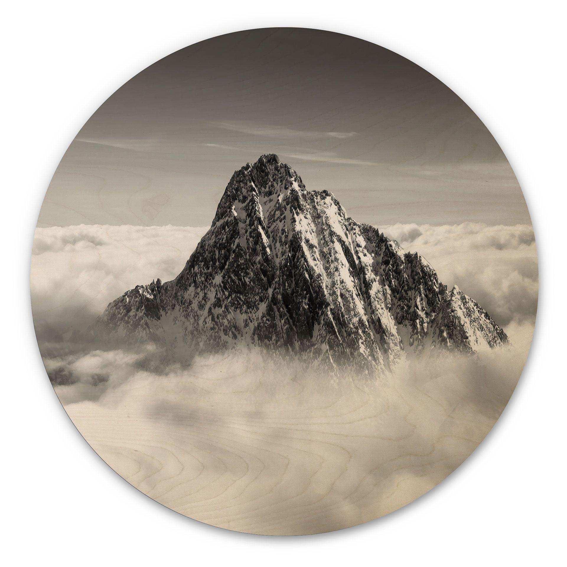 Cuadro de madera pico de montaña sobre las nubes blancas - redondo