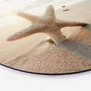 Tableau sur alu-Dibond rond Une étoile de mer étincelante sur une plage déserte