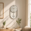 Horloge murale moderne à balancier gris clair avec cadre métallique pour le salon 27x50x4,5 cm