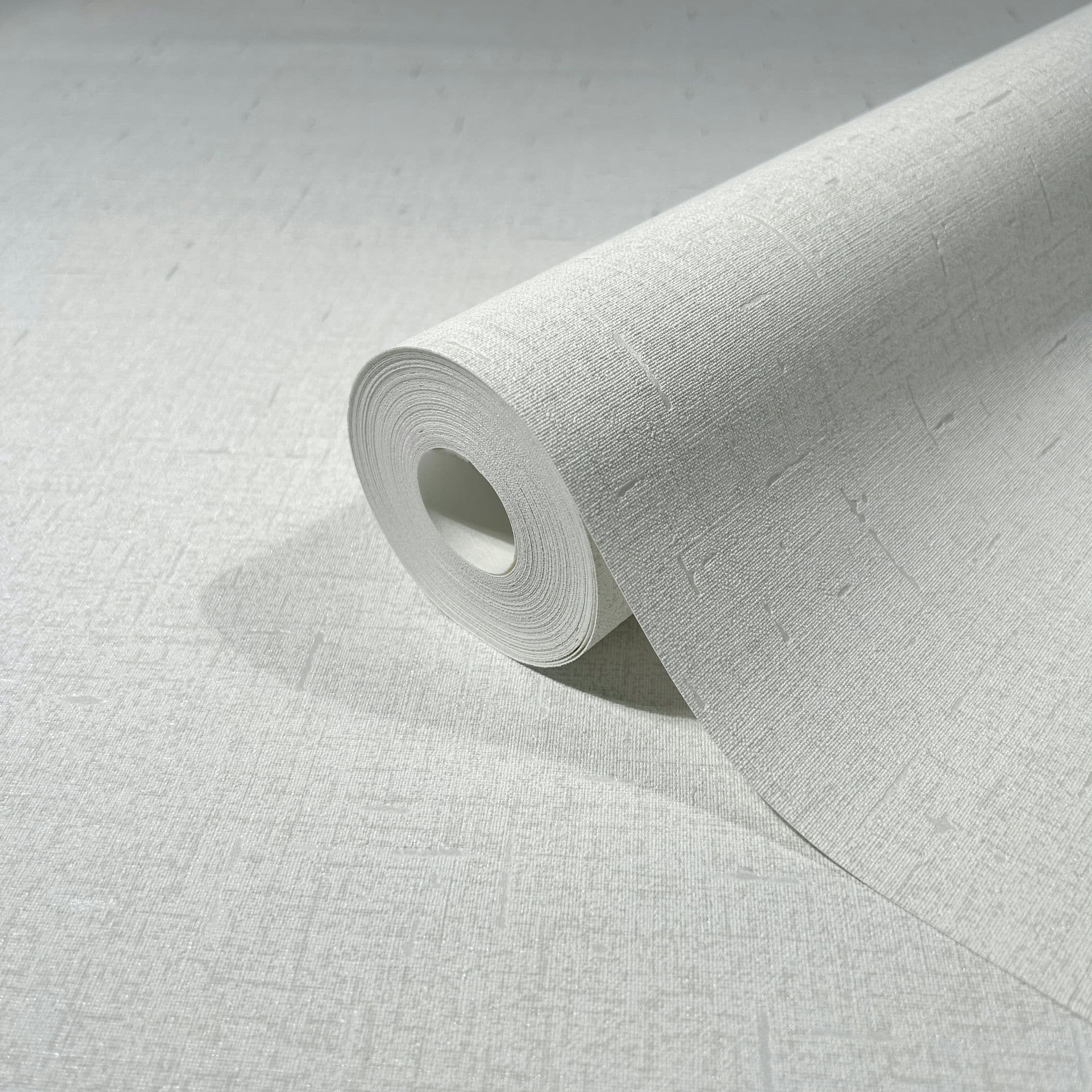 Vliesbehang in een licht glanzende witte effen structuur