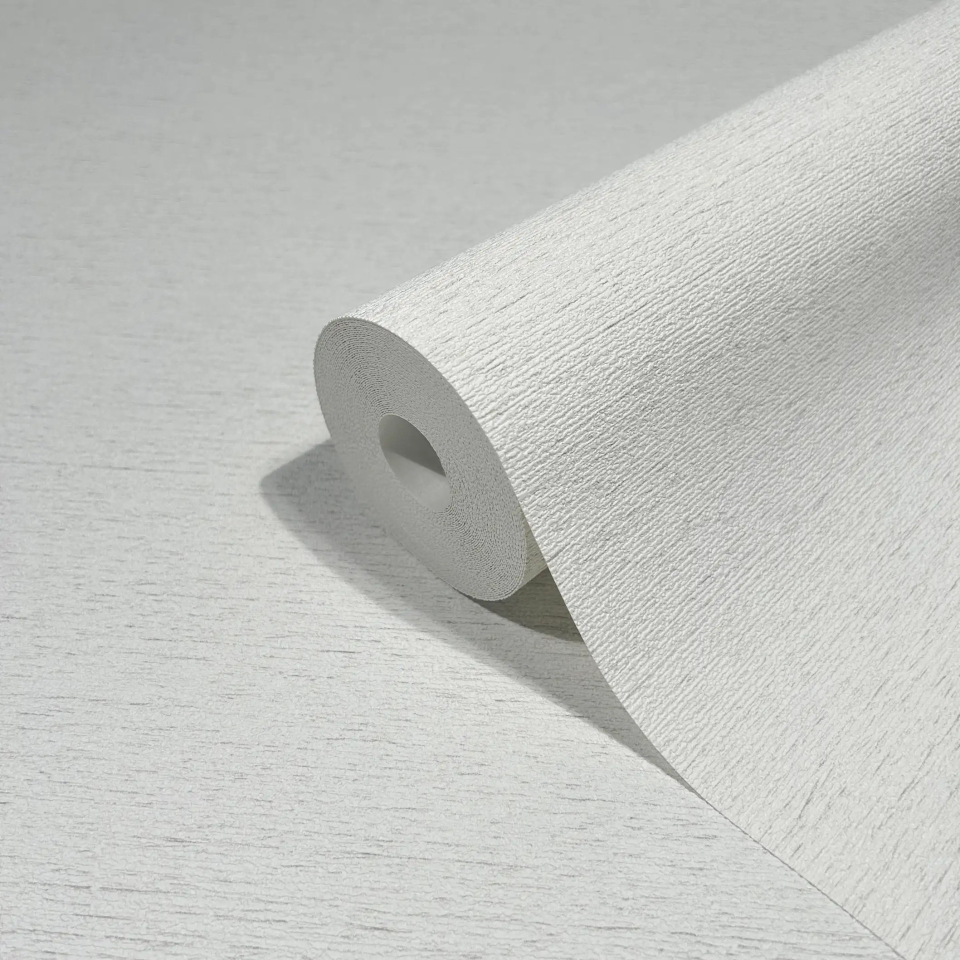 Vliesbehang in een licht gevlekte look als effen wit structuur